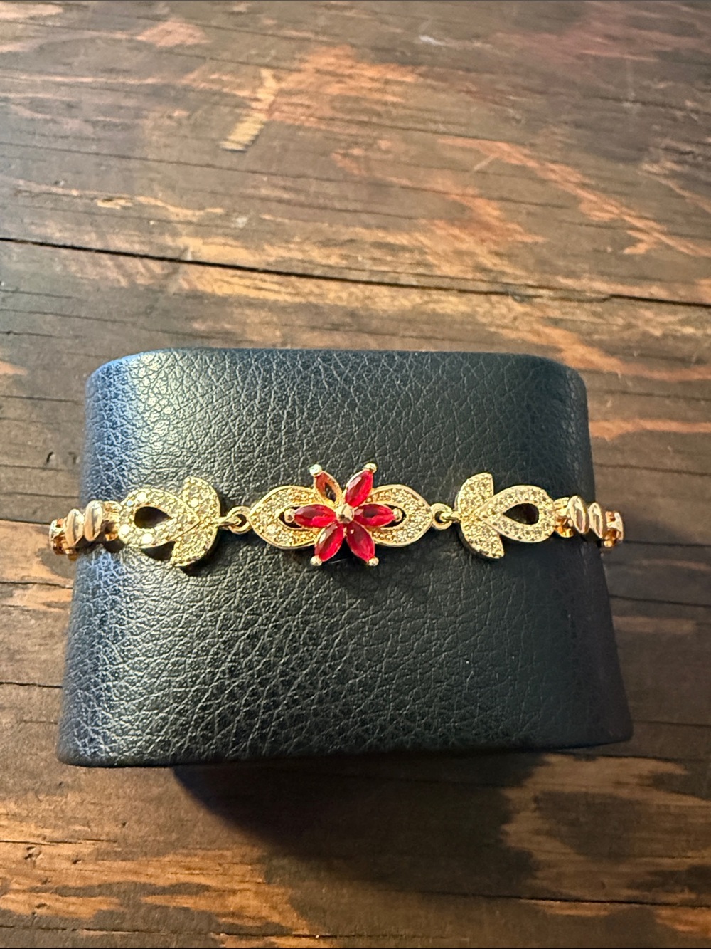 Gold Plated  Floral Bracelet with Red Gem Accents Read